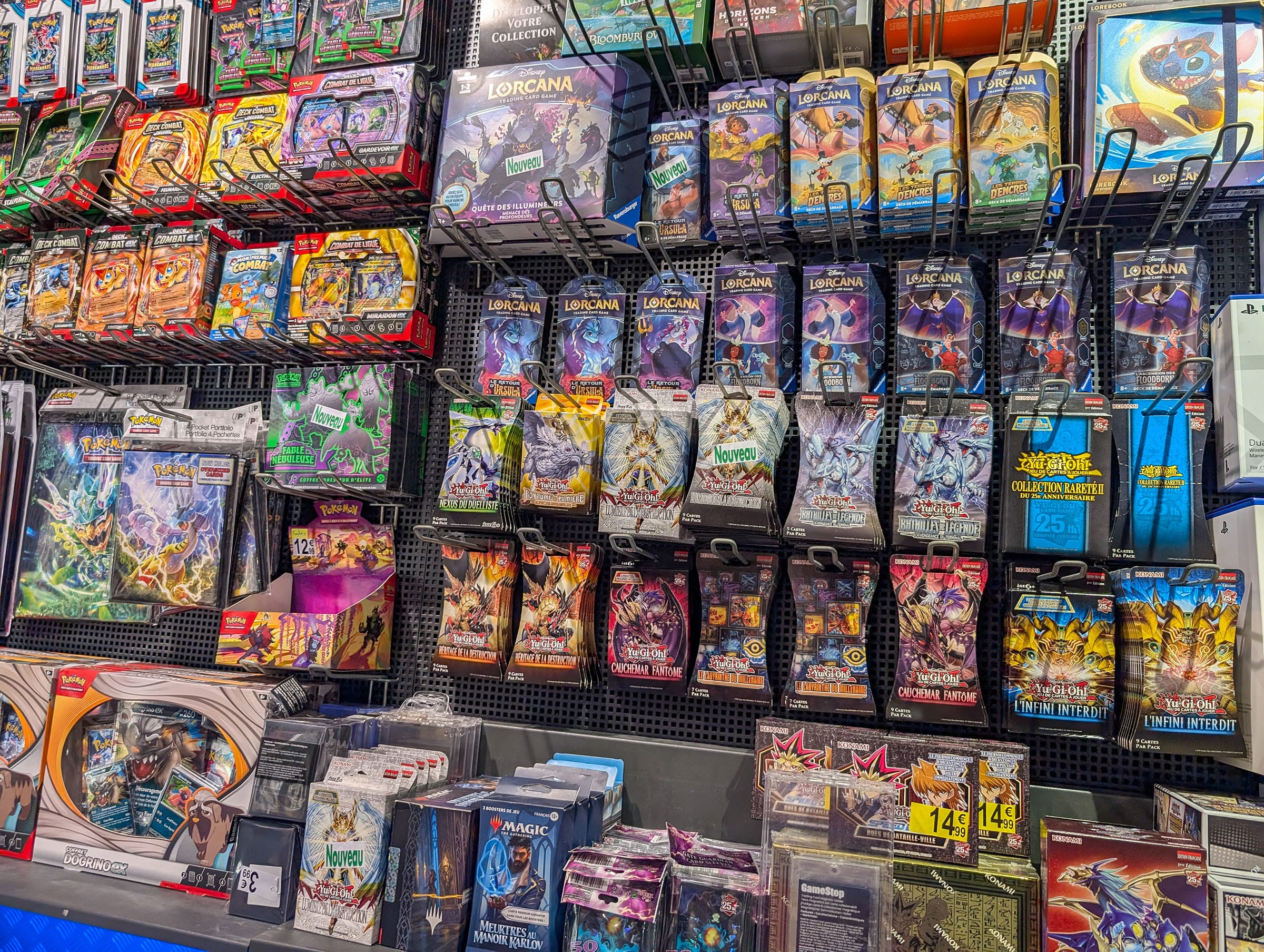 Variety of trading card game packs on display shelf.